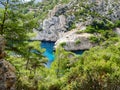 Turquoise blue water among pine trees and white rocks