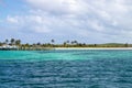 Turquoise blue water at a tropical beach with palm trees Royalty Free Stock Photo