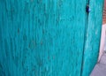 Turquoise blue weathered Garage door with flacking paint and lock Royalty Free Stock Photo