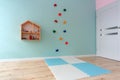 Turquoise children playroom with climbing wall