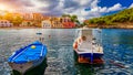 Turquoise colored bay in Mediterranean sea with beautiful colorful houses in Assos village in Kefalonia, Greece. Town of Assos