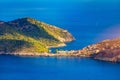 Turquoise colored bay in Mediterranean sea with beautiful colorful houses in Assos village in Kefalonia, Greece. Town of Assos