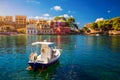 Turquoise colored bay in Mediterranean sea with beautiful colorful houses in Assos village in Kefalonia, Greece. Town of Assos