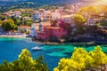 Turquoise colored bay in Mediterranean sea with beautiful colorful houses in Assos village in Kefalonia, Greece. Town of Assos