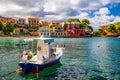 Turquoise colored bay in Mediterranean sea with beautiful colorful houses in Assos village in Kefalonia, Greece. Town of Assos