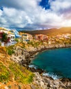 Turquoise colored bay in Mediterranean sea with beautiful colorful houses in Assos village in Kefalonia, Greece. Town of Assos