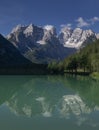 Turquoise coloured lake Duerrensee with view to and refelction Christallo mountain range in Dolomite Alps, South Tyrol Italy