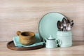 Turquoise crockery, tableware, dishware utensils and stuff on wooden table-top. Kitchen still life as background for design. Royalty Free Stock Photo