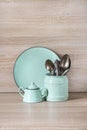 Turquoise crockery, tableware, dishware utensils and stuff on wooden table-top. Kitchen still life as background for design. Royalty Free Stock Photo