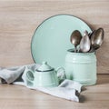 Turquoise crockery, tableware, dishware utensils and stuff on wooden table-top. Kitchen still life as background for design. Royalty Free Stock Photo