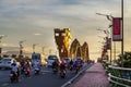 Turquoise dragon bridge with an open flame in Danang Vietnam, evening panorama against the setting sun