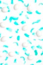 Turquoise feathers and eggs on a white background. minimalistic easter composition. flat lay