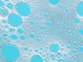 Turquoise froth, foamy background, soap, detergent bubbles on water.