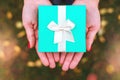 Turquoise gift box in the hands of a girl. Royalty Free Stock Photo