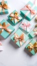 Turquoise Gift Boxes with Pink and Gold Ribbons Arranged on a White Marble Surface Royalty Free Stock Photo
