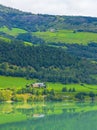 Turquoise green water of fjord river mountains landscape of Norway