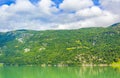 Turquoise green water of fjord river mountains landscape of Norway