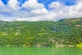 Turquoise green water of fjord river mountains landscape of Norway