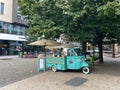 Turquoise ice-cream truck standing under a tree in the streets of Prague, Czech Republic