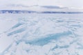 Turquoise ice floe. Ice-drift of Baikal lake. Winter landscape.