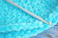 Turquoise knitted round carpet or rug.