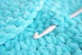 Turquoise knitted round carpet or rug.