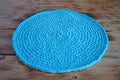 Turquoise knitted round carpet or rug.