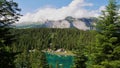 Turquoise lake Caumasee surrounded by forest reflected in the water near Flims, Grisons, Switzerland. Royalty Free Stock Photo