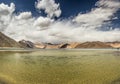 Turquoise lake in the Himalayas tibet mountains with clouds and blue sky Royalty Free Stock Photo