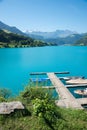 turquoise lake Lungernsee, with boardwalk and boats. landscape switzerland Royalty Free Stock Photo