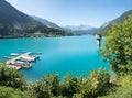 turquoise lake Lungernsee, with boardwalk and boats, observation tower Royalty Free Stock Photo