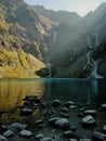 Turquoise lake in mountans with sun rays Royalty Free Stock Photo