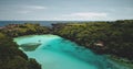 Turquoise lake with resting people aerial view. Tourists swimming at azure crystal clean lagoon