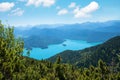 Turquoise lake walchensee, view from herzogstand mountain, bavarian alps. blue sky with fluffy clouds Royalty Free Stock Photo