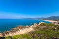 Turquoise Mediterranean sea with cumulus clouds at the Plage de l`Alga on the rocky coast of La Revellata near Calvi.