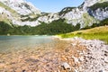 Turquoise mountain lake with crystal pure waters surrounded by rocky mountains