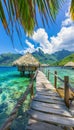 Turquoise ocean with wooden walkway leading to overwater bungalows at tropical resort