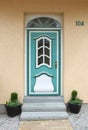 Turquoise old wooden door, with glass window and skylight