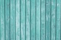 Turquoise painted wooden fence with vertical planks. Soft green paint wood background. Shabby, weathered timber in vintage style. Royalty Free Stock Photo
