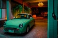 Turquoise retro car in the night garage in the light of the light. The calm after a day`s work Royalty Free Stock Photo