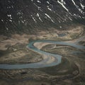 Turquoise river bends through landscape of Jotunheimen National Park in Norway