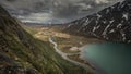 Turquoise river bends through mountain landscape of Jotunheimen National Park in Norway