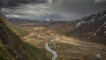 Turquoise river bends through mountain landscape of Jotunheimen National Park in Norway