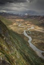 Turquoise river bends through mountain landscape of Jotunheimen National Park in Norway