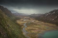 Turquoise river bends through mountain landscape of Jotunheimen National Park in Norway