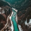 A turquoise river running through a wintery mountain forest and trees covered in snow