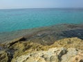 Turquoise sea of crystal clear water from rocky coast