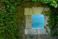 Turquoise Sea through an old Exterior Window