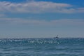 Turquoise sea in sunny sparks on a sunny day. Small boat on the water. Alboran Sea in Benalmadena. Andalusia, Spain Royalty Free Stock Photo