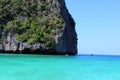 Turquoise sea water with huge mountain with trees